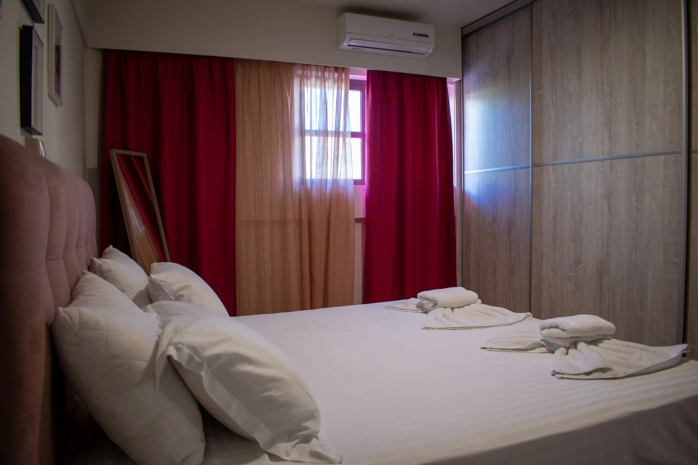 Bedroom with upholstered bed and sliding wardrobe