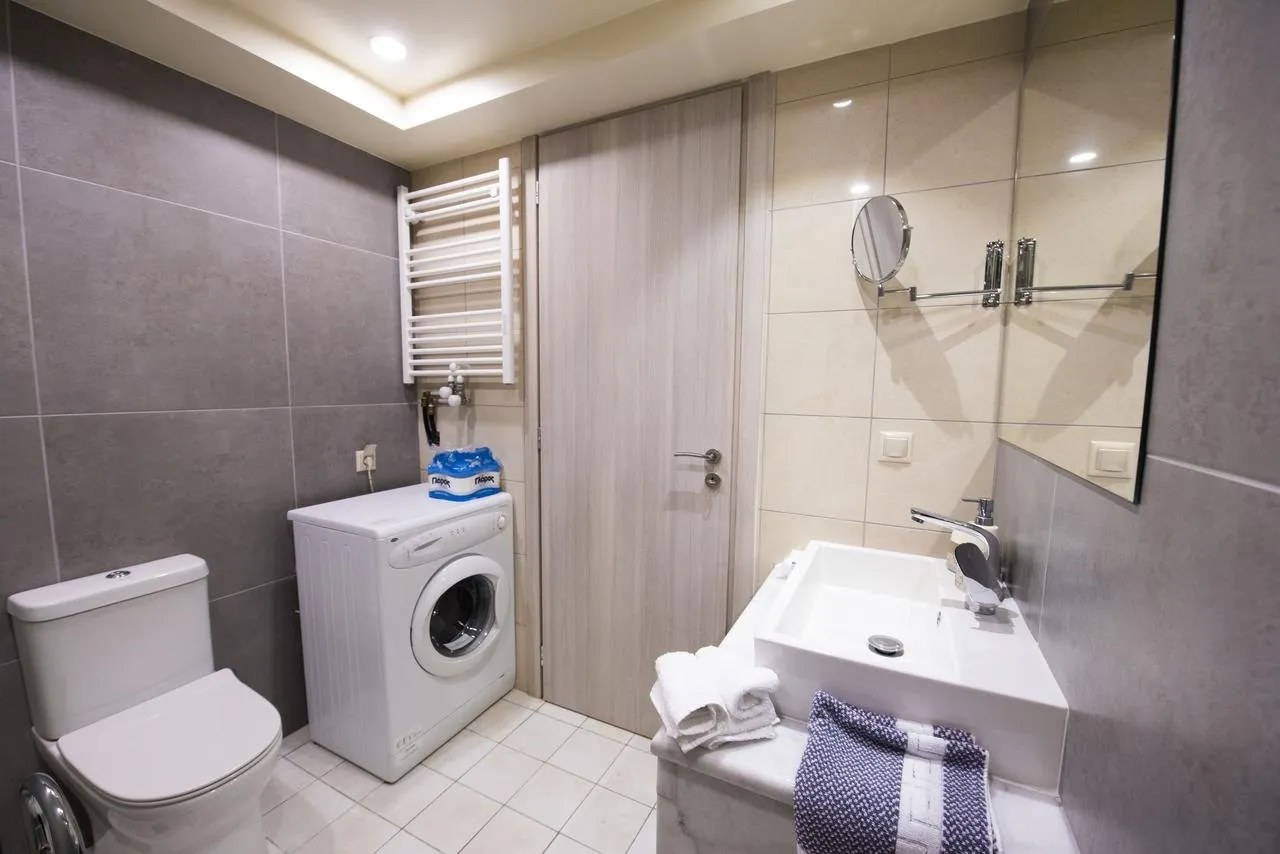 Bathroom with shower, washing machine and towel rail