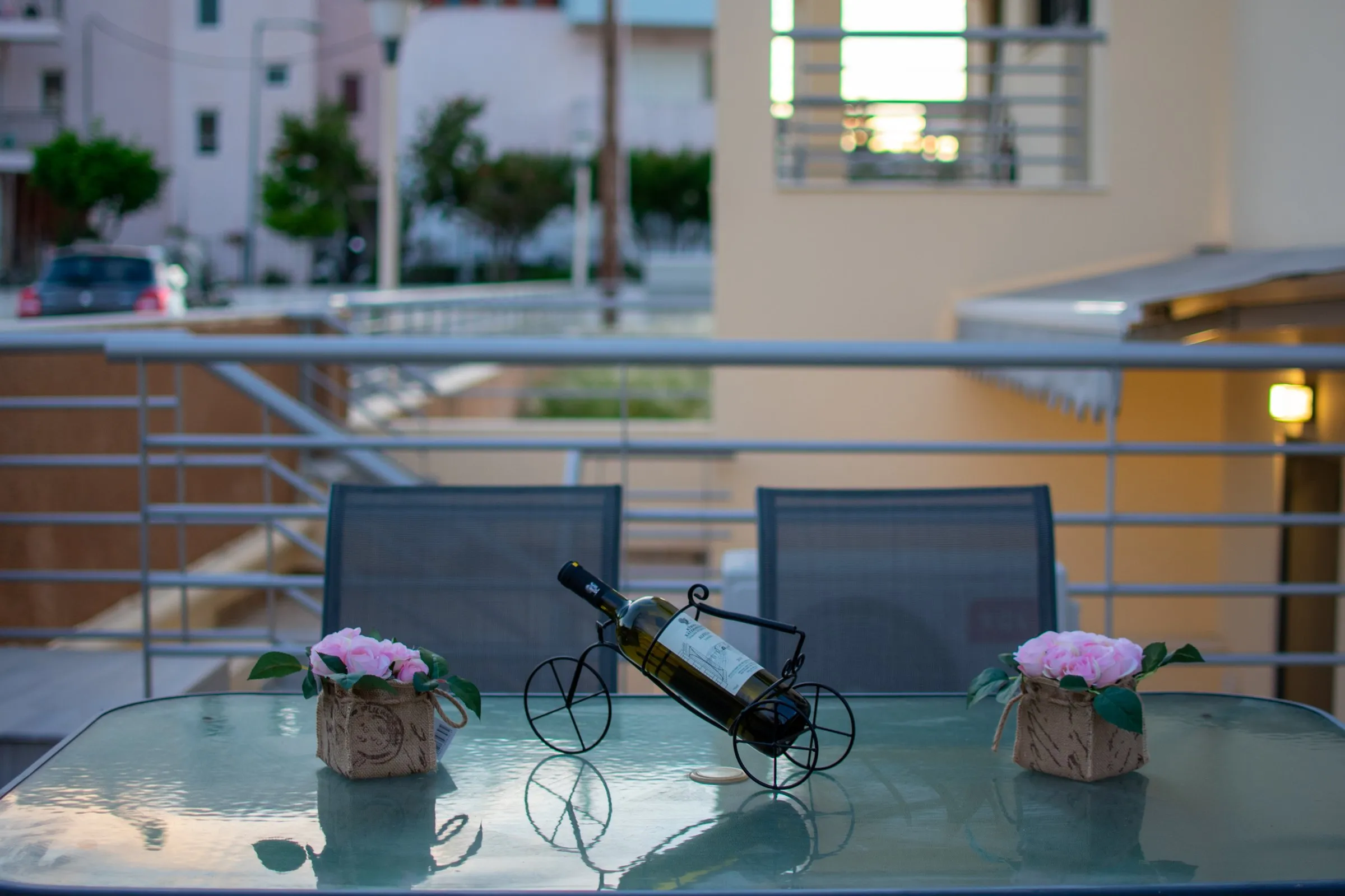 Terrace table with flowers and a bottle of wine